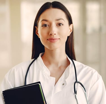 Female doctor with long brown hair wearing lab coat and stethoscope and holding a black notebook