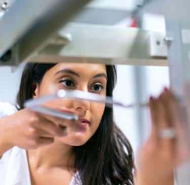 female technician of color adjusting equipment