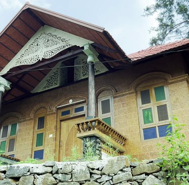 a house with a stone wall and a stone wall