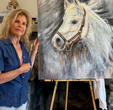 “Artist Renee Dumont pictured with Felix’s memorial horse portrait.”