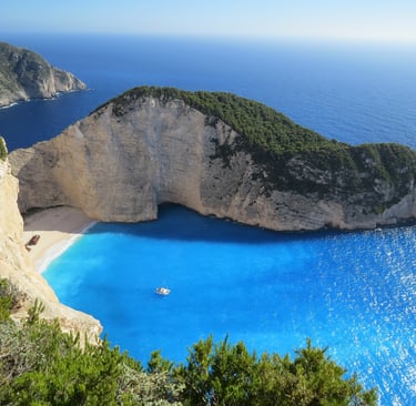 a boat in the water near a cliff