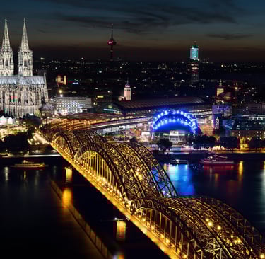 a bridge spanning a river with a cathedral in the background