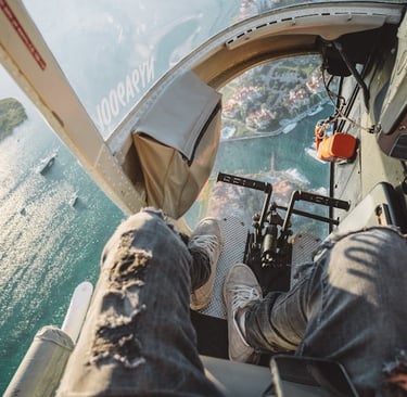 a person sitting in a helicopter with a view of a city