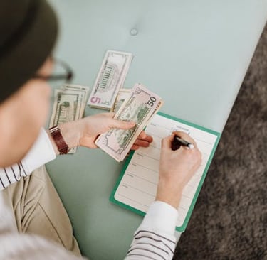 a man in a hat and a notebook with money
