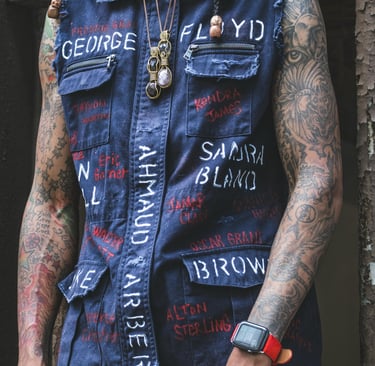 a man with tattoos on his arm and a watch on his wrist