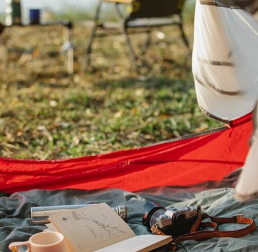 a person sitting in a hammock with a cup of coffee