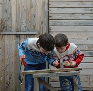 two boys playing with a hammer hammer and a hammer hammer