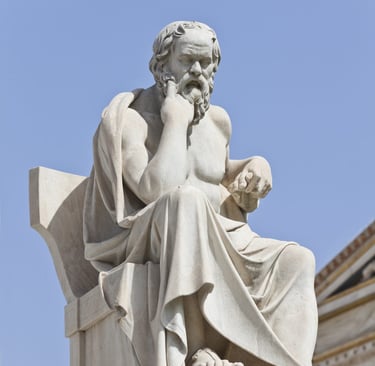 a statue of Socrates sitting on a bench