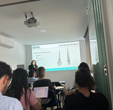 a woman in a white shirt is standing in front of a presentation