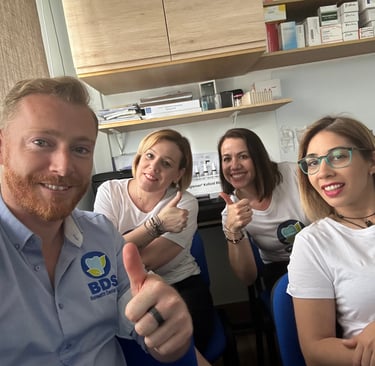a group of people sitting at a table with thumbs up