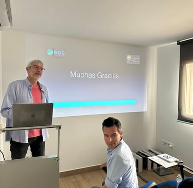 a man standing in front of a presentation screen
