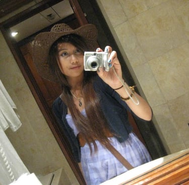 Highschooler Ari taking a mirror selfie with the silver Olympus.