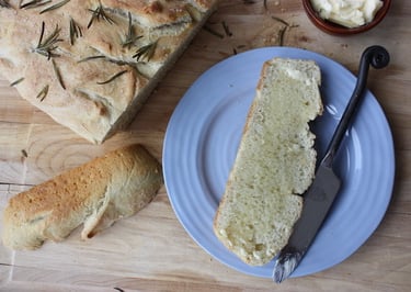 sliced rosemary focaccia bread with melted butter