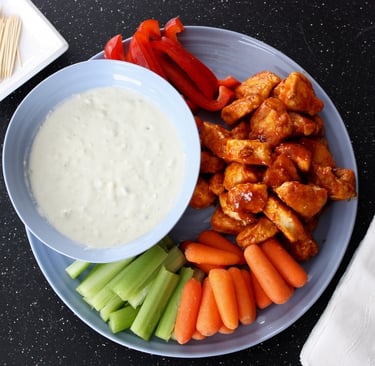 buffalo chicken bites with blue cheese dip and vegetables