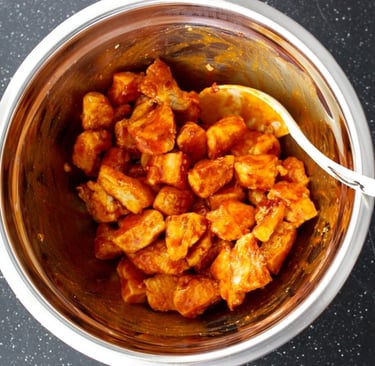 chunks of chicken fried and tossed in buffalo sauce