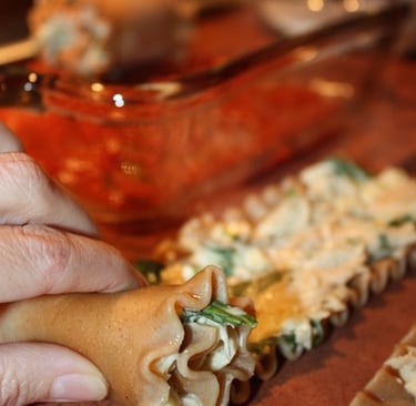 rolling lasagna noodles with chicken cheese mixture