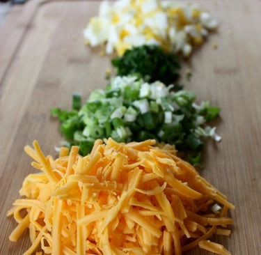 chopped and grated ingredients needed for stuffed potatoes