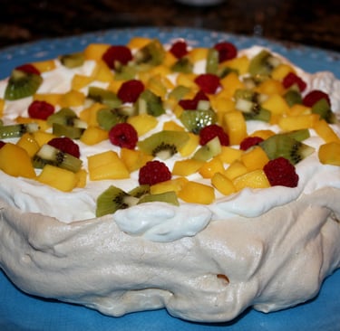 pavlova with raspberries, kiwi, and mango