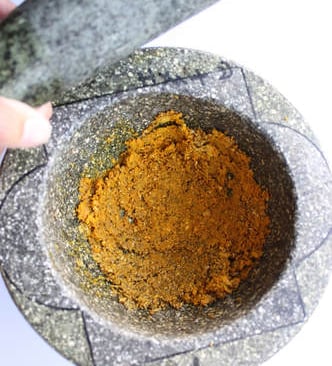 marinade paste in mortar and pestle for Thai chicken satays