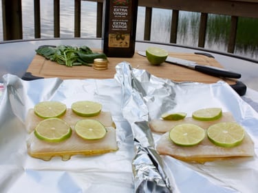 uncooked fish topped with lime slices sitting on tinfoil