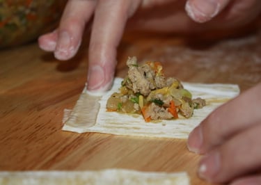 using flour and water to seal the edges of the wonton wrapper