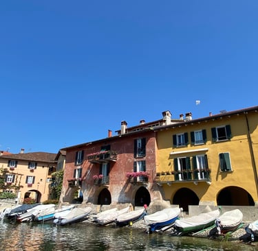 Mandello del Lario village on Lake Como with colorful boats along the shore