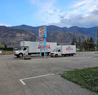 Canada’s Most Wanted Movers fleet parked at Elks Motel with mountain views during a long-distance move in BC.
