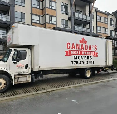 Canada’s Most Wanted Movers truck parked outside a condo complex in Langley for an apartment move.