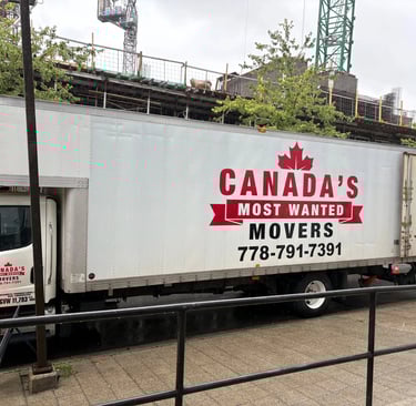 Canada’s Most Wanted Movers truck parked beside a construction project in Surrey, ready for a commercial move.