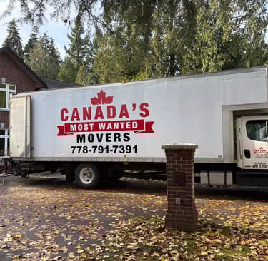 Canada’s Most Wanted Movers truck parked at a forest-side home in the Lower Mainland during a residential move.
