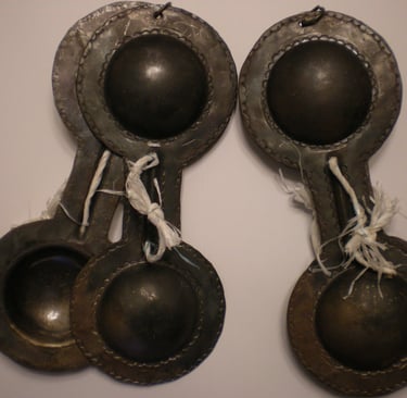 a pair of antique metal spoons with a pair of spoons