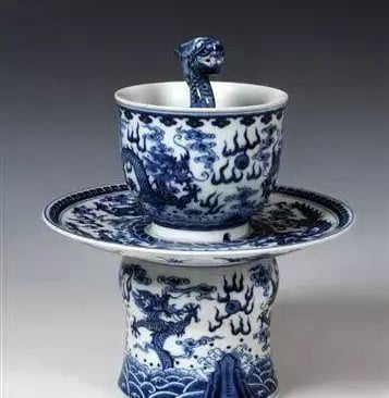 A ceramic cup featuring a dragon design