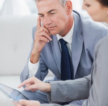 a business man and woman sitting at a desk