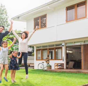 a family of four children jumping in the air near their huse in zambales