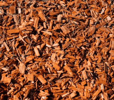 a pile of wood chips sitting on top of a pile of wood chips