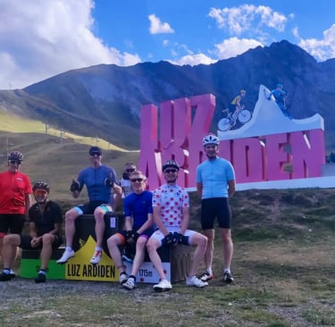 a group of people standing in front of a sign that says Luz Ardiden