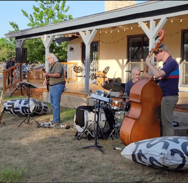 a group of musicians playing instruments outdoors