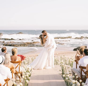 Bride and groom kissing on the beach destination wedding