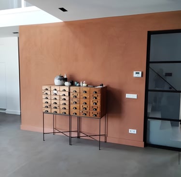 a room with a table and a cabinet with drawers