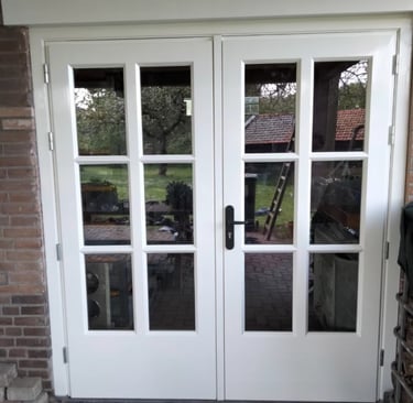 a white door with a brick wall and a brick wall