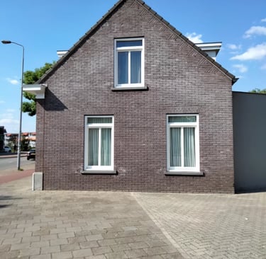 a house with a brick wall and a brick wall