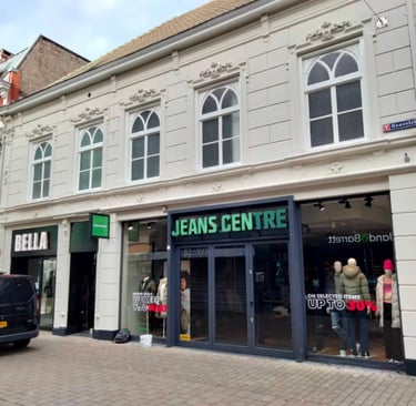 a storefront of a storefront with a car parked in front of it