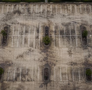 Top down view of a parking lot before getting pressure washed