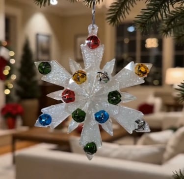 White glitter snowflake Christmas ornament with colorful jingle bells hanging on a tree.
