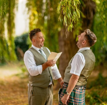 Groom reading a wedding letter to his spouse at Tall John’s House, filled with laughter and true emotion
