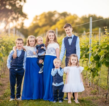 A group photo of child wedding guests ay sunset at llanerch vineyard
