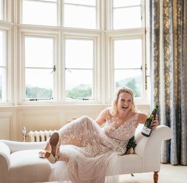 a woman in a white dress sitting on a couch