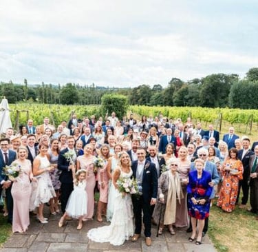 The everyone photo. All wedding guests standing in front of Llanerch vineyard.