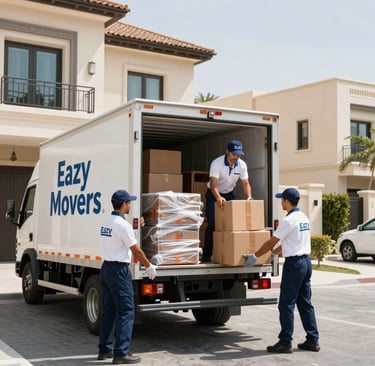 Professional movers of Eazy Movers truck outside a house.