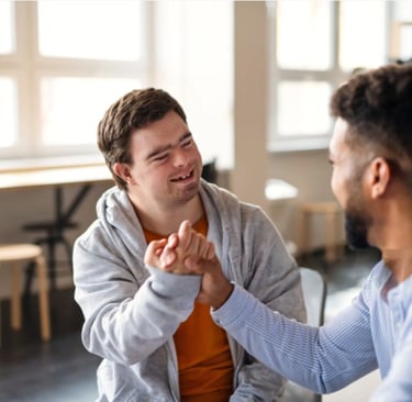 NDIS participant smiling and sharing a friendly moment with a support worker